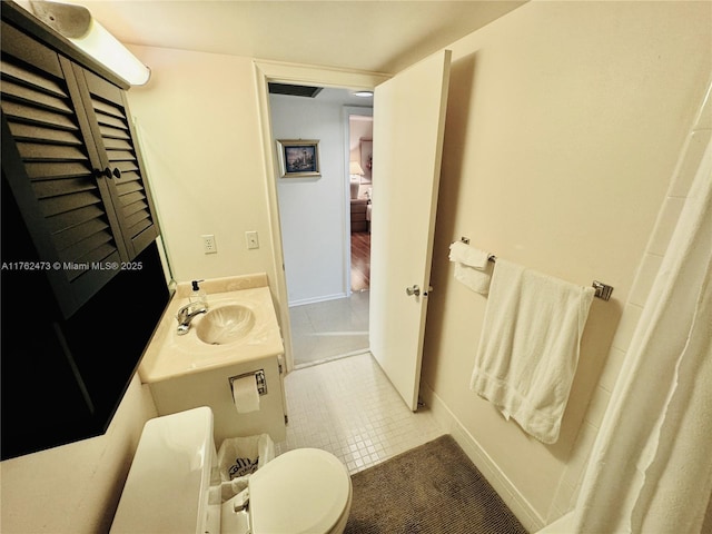 full bathroom with tile patterned flooring, toilet, and vanity