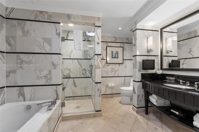 bathroom featuring vanity, a garden tub, a shower stall, tile walls, and toilet