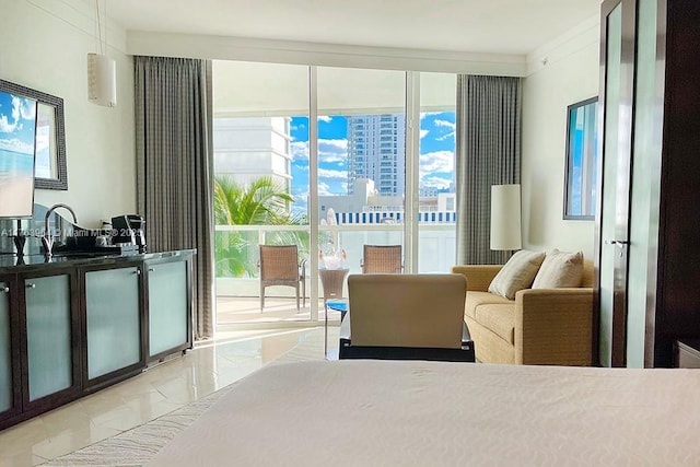 bedroom featuring access to exterior, floor to ceiling windows, and multiple windows