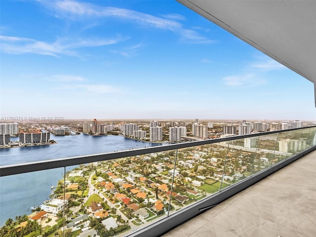 balcony featuring a city view, a water view, and central AC