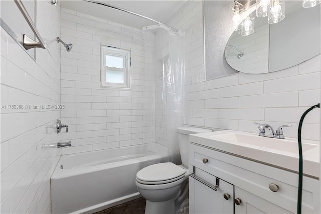 full bath with vanity, shower / tub combination, tile walls, toilet, and tasteful backsplash