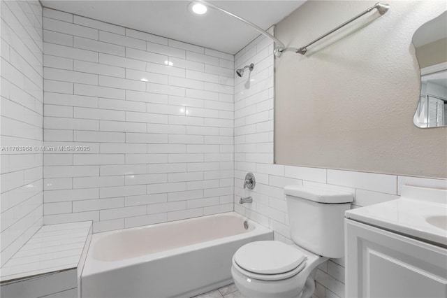 full bath with vanity, toilet, tile walls, and  shower combination