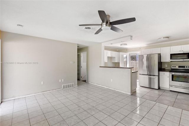 kitchen featuring white cabinetry, dark countertops, visible vents, and stainless steel appliances