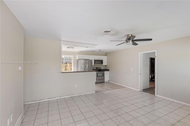 unfurnished living room with visible vents, baseboards, ceiling fan, and light tile patterned flooring