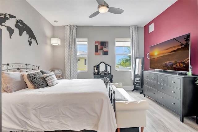 bedroom featuring a ceiling fan, light wood-type flooring, and baseboards