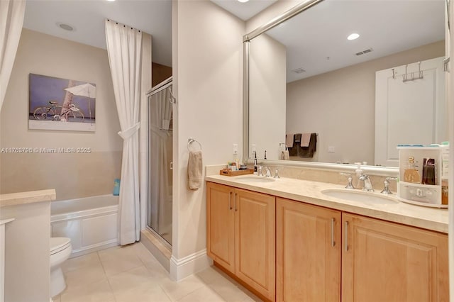 bathroom featuring a shower stall, double vanity, visible vents, and a sink