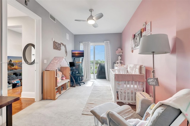 sitting room with baseboards, visible vents, and ceiling fan