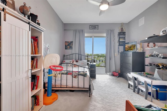 bedroom featuring access to exterior, visible vents, ceiling fan, carpet, and a barn door