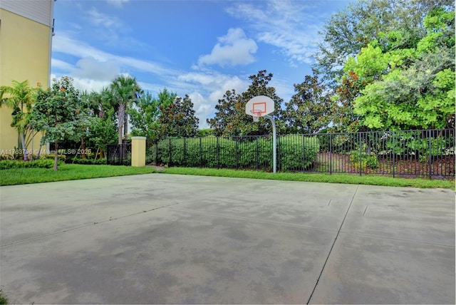 view of patio featuring community basketball court and fence