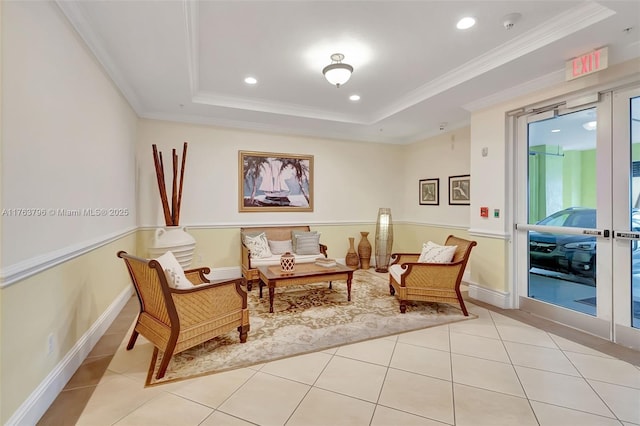 sitting room with tile patterned floors, a raised ceiling, ornamental molding, recessed lighting, and baseboards