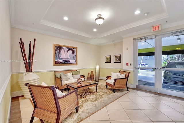 interior space with light tile patterned flooring, recessed lighting, crown molding, and a tray ceiling