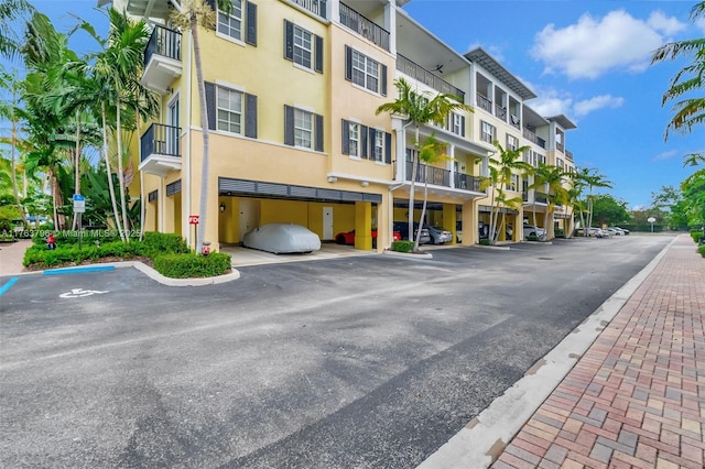 view of property with covered and uncovered parking