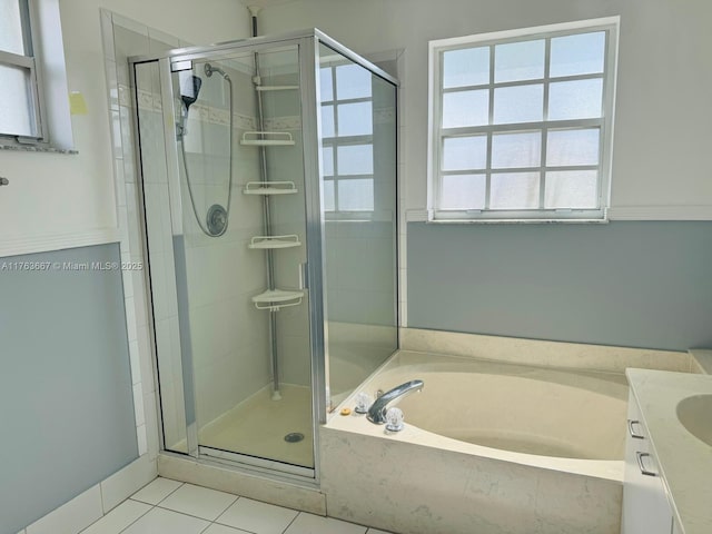 full bath featuring tile patterned flooring, a shower stall, vanity, and a garden tub