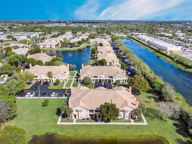 drone / aerial view with a residential view and a water view