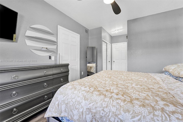 bedroom featuring a closet, visible vents, and a ceiling fan