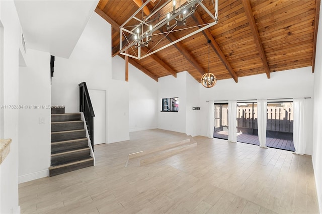 unfurnished living room featuring stairway, wood finished floors, an inviting chandelier, beam ceiling, and wood ceiling