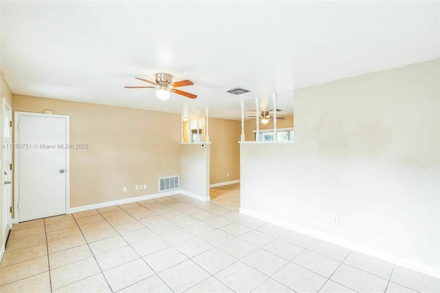 spare room featuring light tile patterned flooring, visible vents, and a ceiling fan