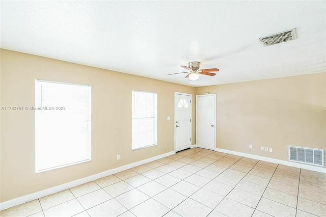 empty room featuring visible vents, baseboards, and ceiling fan