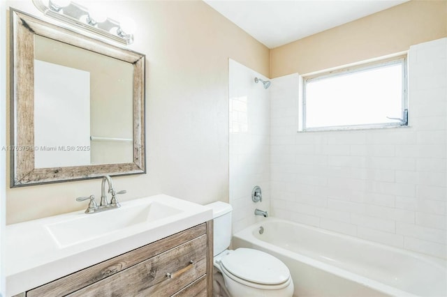 bathroom featuring toilet, vanity, and shower / tub combination