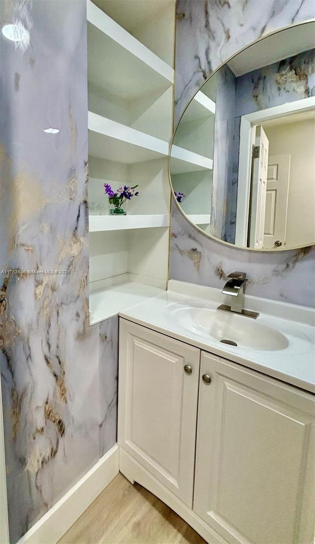 bathroom with vanity and wood finished floors