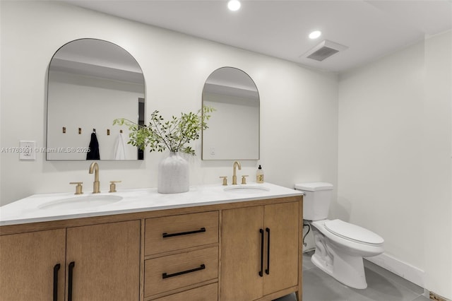 bathroom with a sink, visible vents, toilet, and double vanity