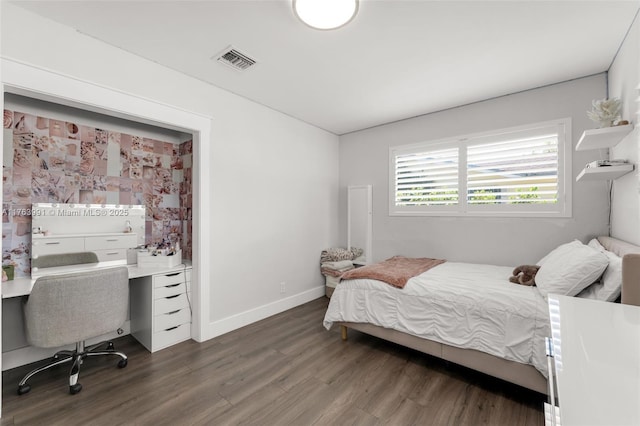 bedroom featuring visible vents, baseboards, and dark wood-style floors