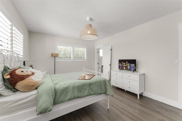 bedroom featuring baseboards and wood finished floors