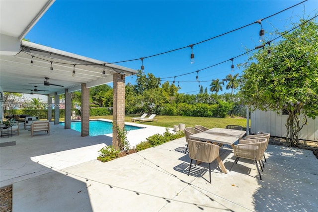 view of patio featuring an outdoor pool, outdoor dining area, and ceiling fan