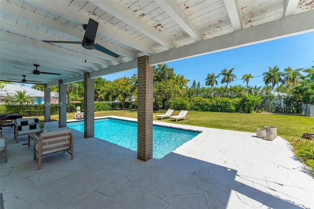 pool featuring a yard, a patio, and a ceiling fan