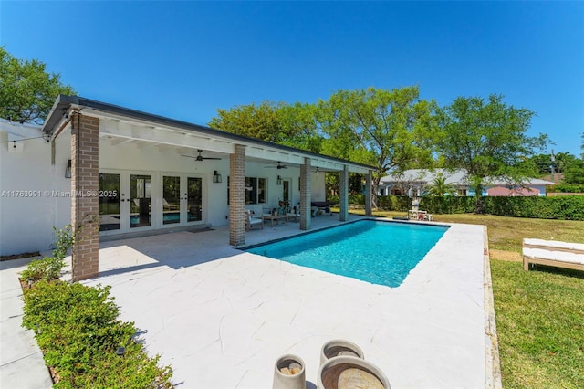 pool with ceiling fan, french doors, and a patio