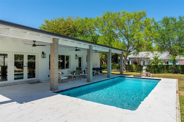 view of pool featuring french doors, a patio, a fenced in pool, and ceiling fan