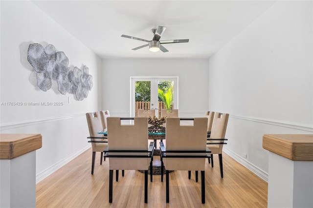 dining room featuring baseboards, wood finished floors, and a ceiling fan
