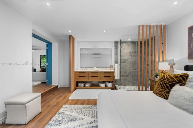full bath featuring wood finished floors, a stall shower, and recessed lighting