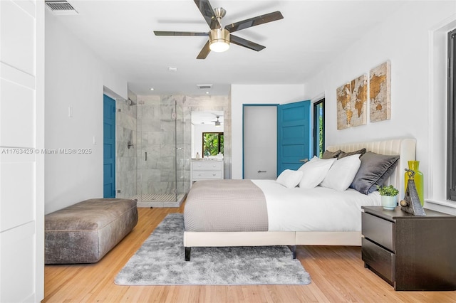 bedroom featuring a ceiling fan, wood finished floors, and visible vents