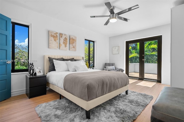 bedroom featuring french doors, access to outside, ceiling fan, and light wood-type flooring