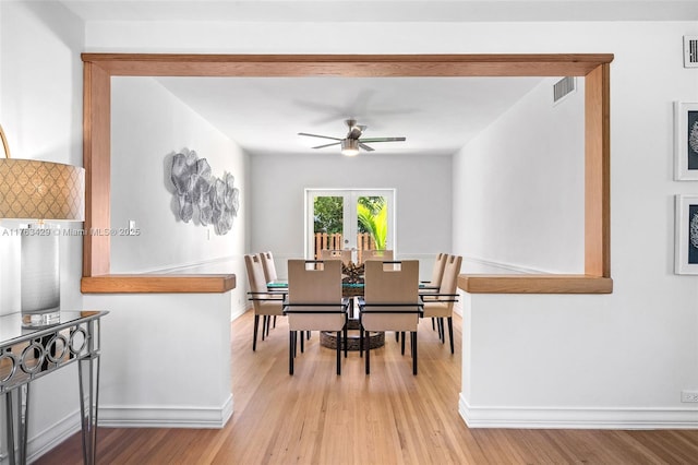 dining area with baseboards, visible vents, light wood-style floors, and a ceiling fan