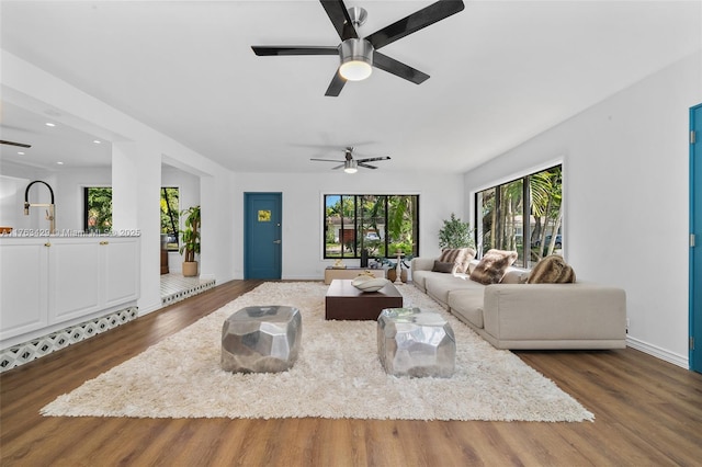 living area with baseboards, ceiling fan, wood finished floors, and recessed lighting