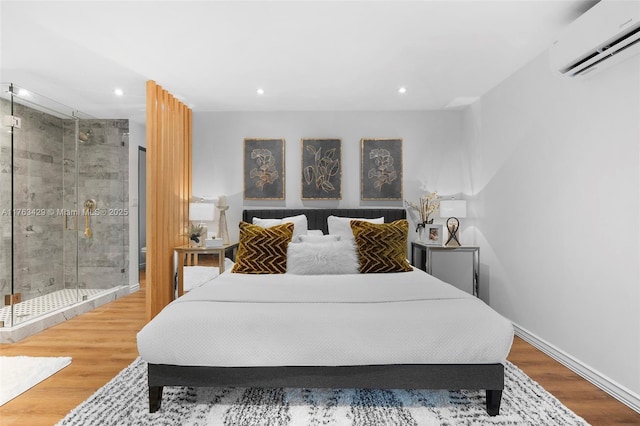 bedroom with baseboards, wood finished floors, an AC wall unit, and recessed lighting