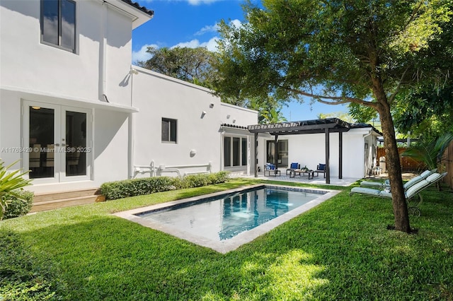 rear view of house with a pergola, stucco siding, a patio, and french doors
