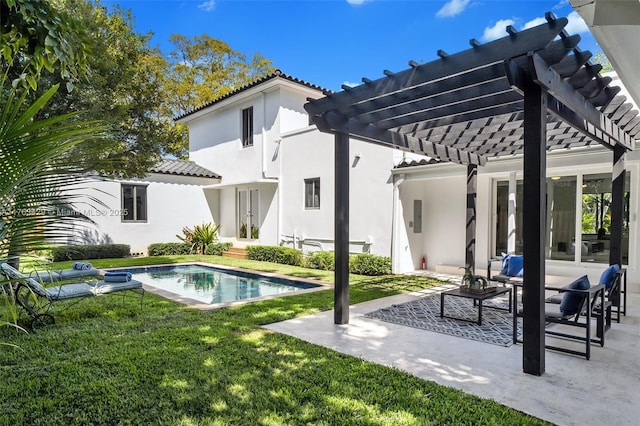 back of house featuring a pergola, a tiled roof, a yard, and a patio area