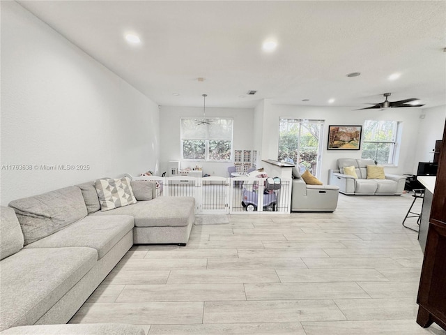 living room with visible vents, recessed lighting, a ceiling fan, and wood finish floors