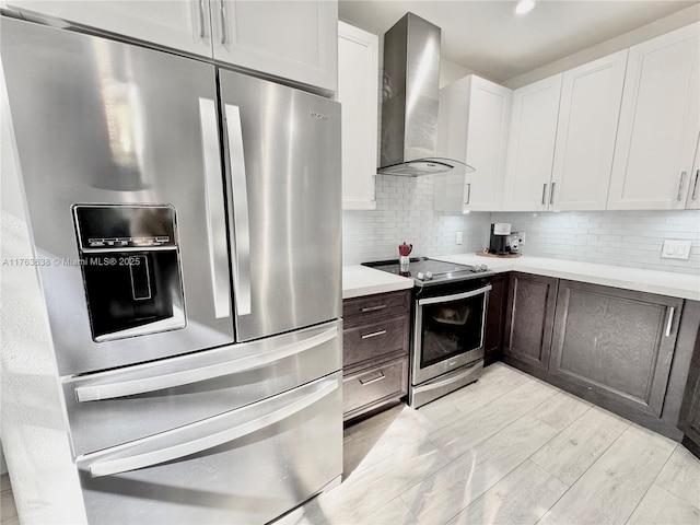 17130 SW 36th Ct Unit 17130, Miramar, FL 33027 - kitchen featuring backsplash, white cabinetry, stainless steel appliances, wall chimney exhaust hood, and light countertops