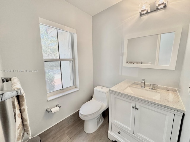 17130 SW 36th Ct Unit 17130, Miramar, FL 33027 - half bath featuring a healthy amount of sunlight, toilet, vanity, and wood finished floors