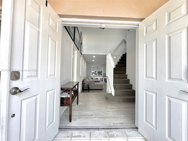 entryway with stairs and light wood-style floors