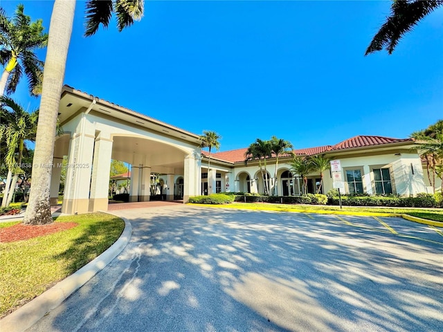 view of front of home with a tile roof and stucco siding