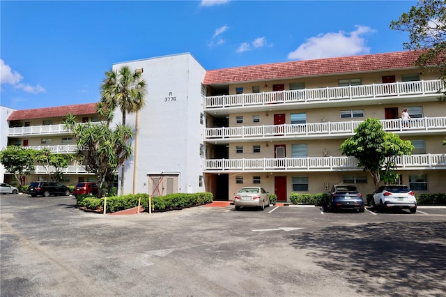 view of building exterior with uncovered parking