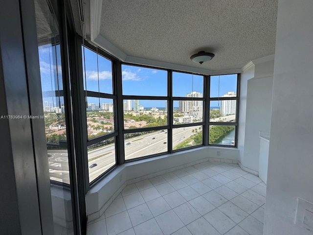 unfurnished sunroom featuring a view of city