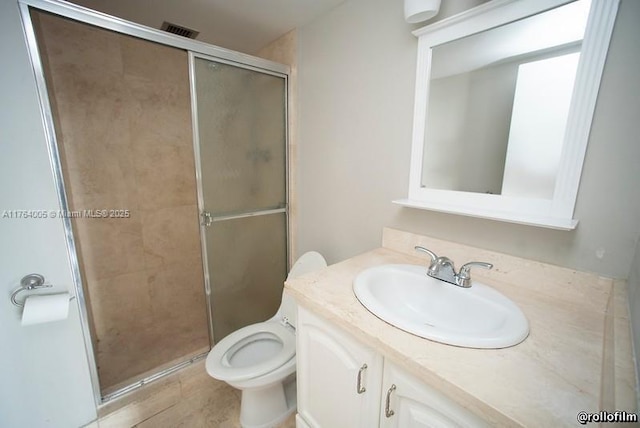 full bathroom with vanity, toilet, visible vents, and a stall shower