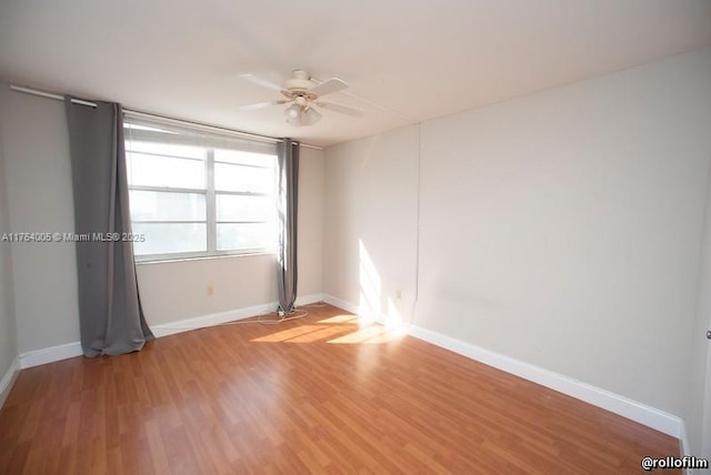 unfurnished room with baseboards, light wood-style floors, and a ceiling fan