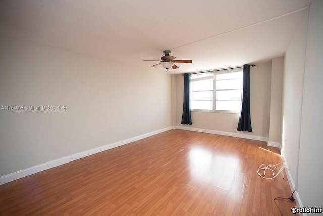 unfurnished room with a ceiling fan, light wood-type flooring, and baseboards